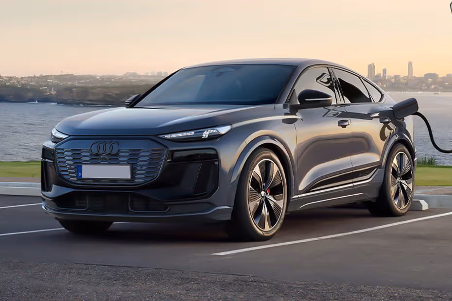 Audi Q6 Sportback e-tron 2026 front left side angle view on city street