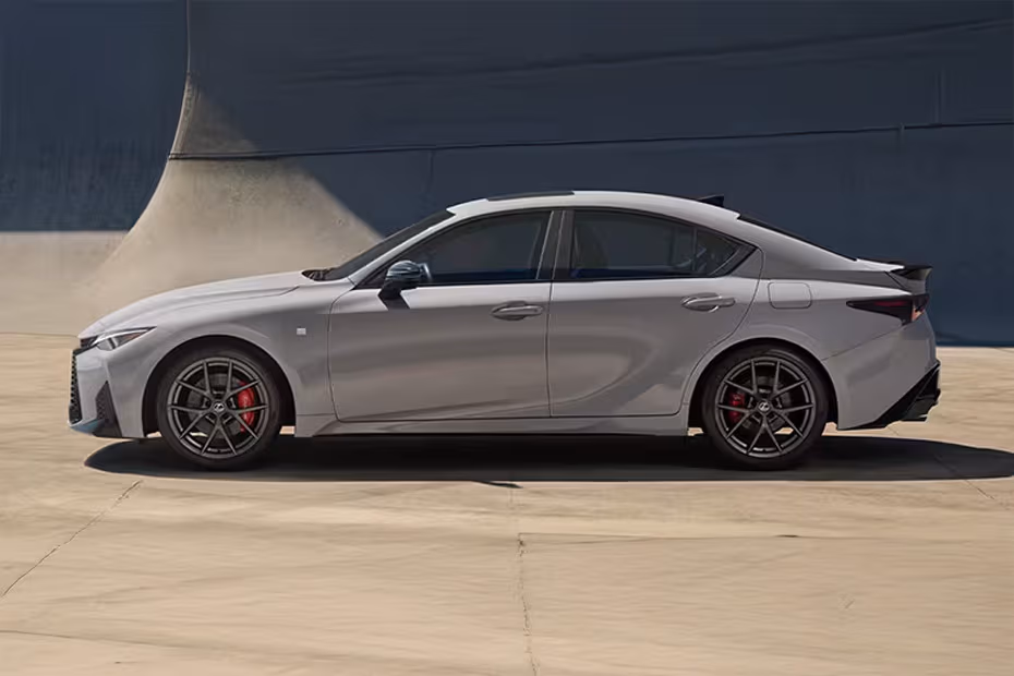 Lexus IS 2026 left side angle view showing taillights, tailgate and alloy wheels